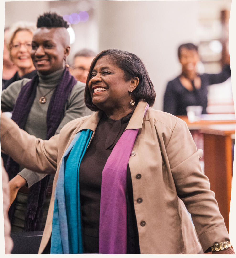 Smiling black woman with crowd in the background