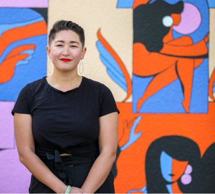 Samantha in front of a colorful wall