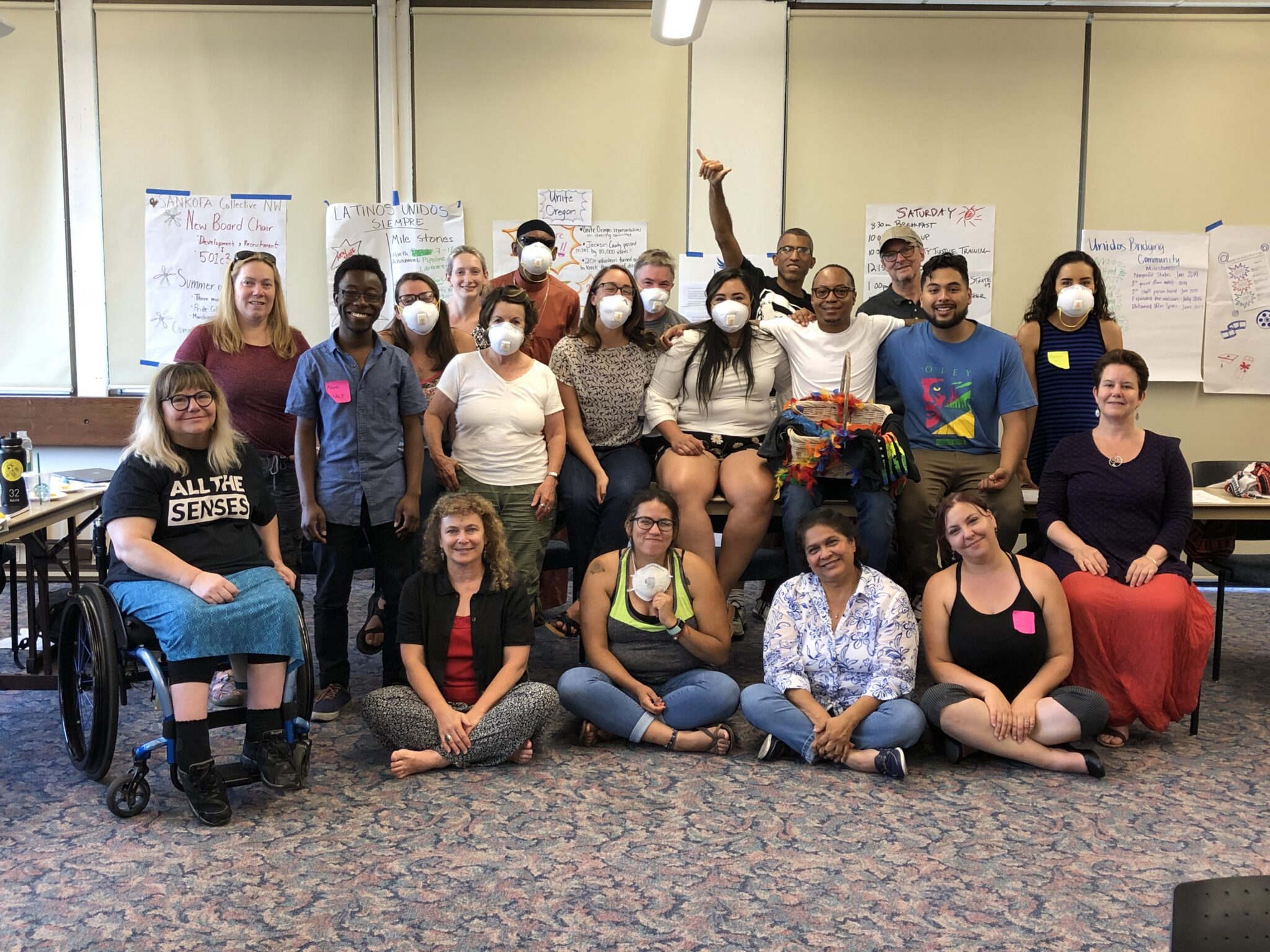 A group photo of the Capacity Building Initiative cohort wearing smoke masks.