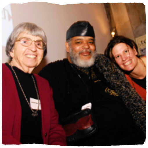 Seeding Justice co-founder Leslie Brockelbank and artist Bobby Fouther smile at the camera.