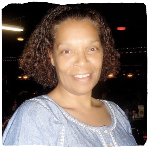 Wearing a chambray top and short, curly hair, Liz Fouther Branch smiles into the camera.